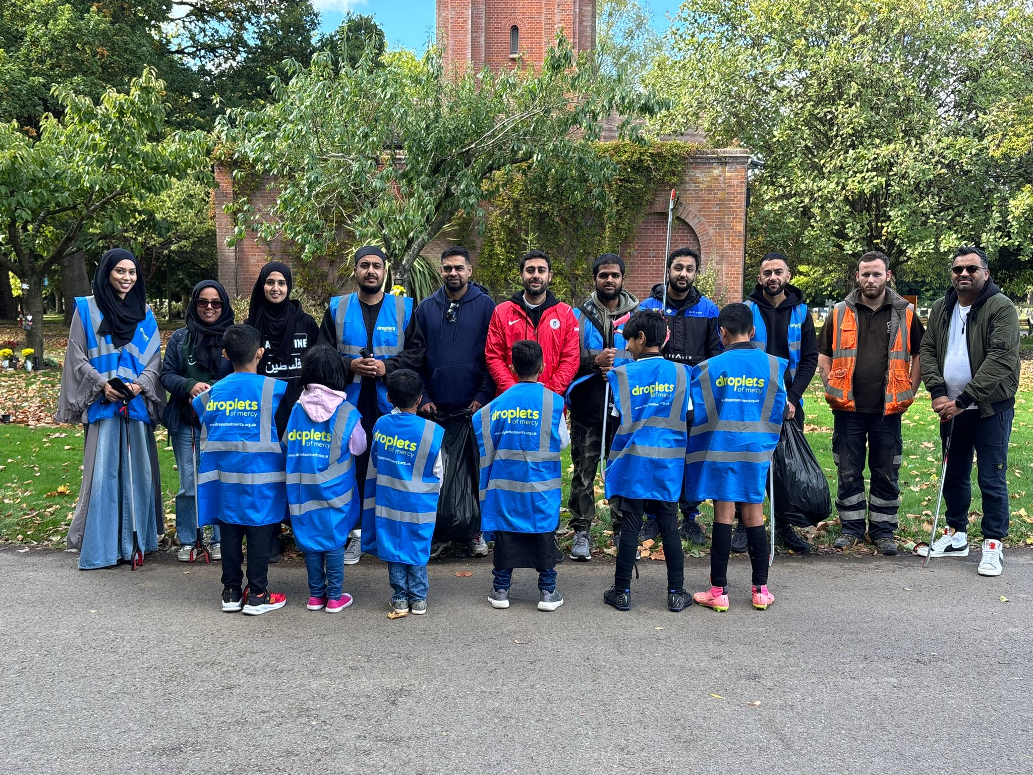 Droplets of Mercy volunteers in hi-vis vests at a community park