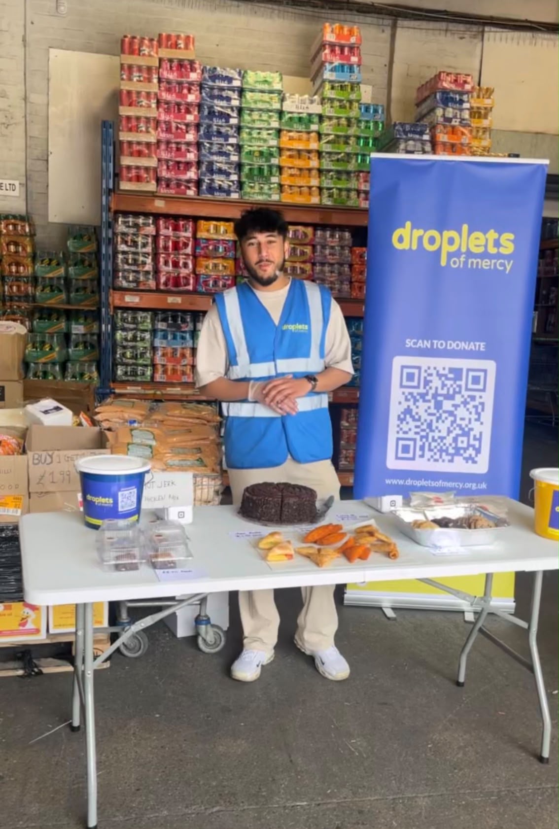 Droplets of Mercy fundraising stall with a Scan to Donate banner